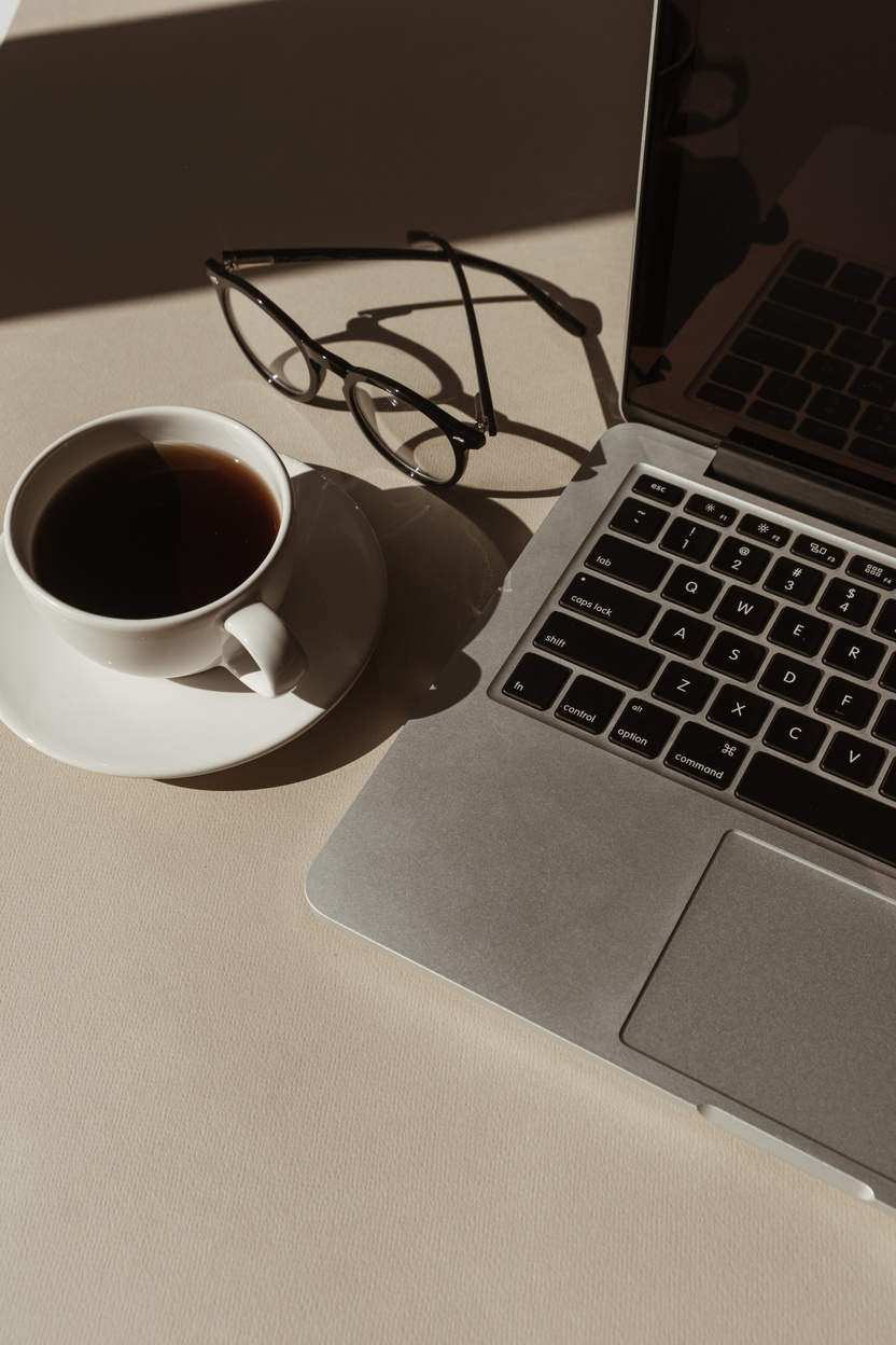 Coffee, Laptop, and Eyeglasses on the Table